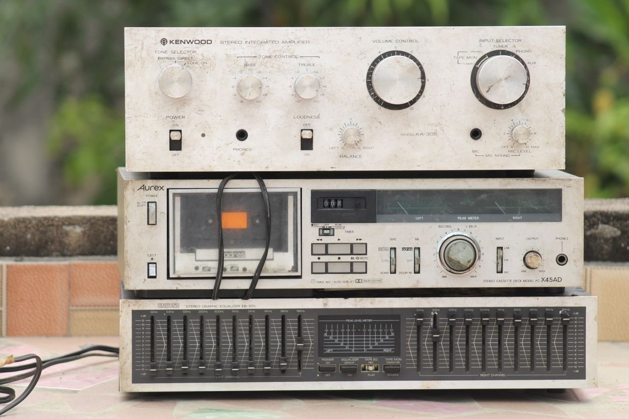 Retro stereo setup with vintage Kenwood amplifier and graphic equalizer on display.